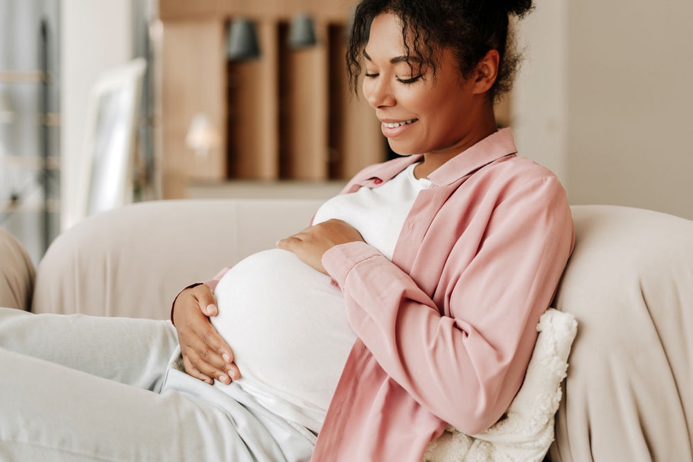 pregnant woman sitting on couch.