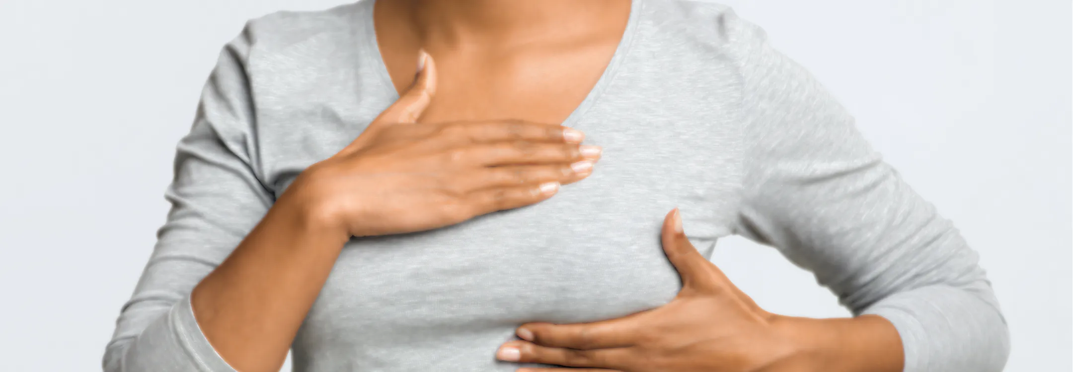 Close-up of a woman performing a breast self-examination.