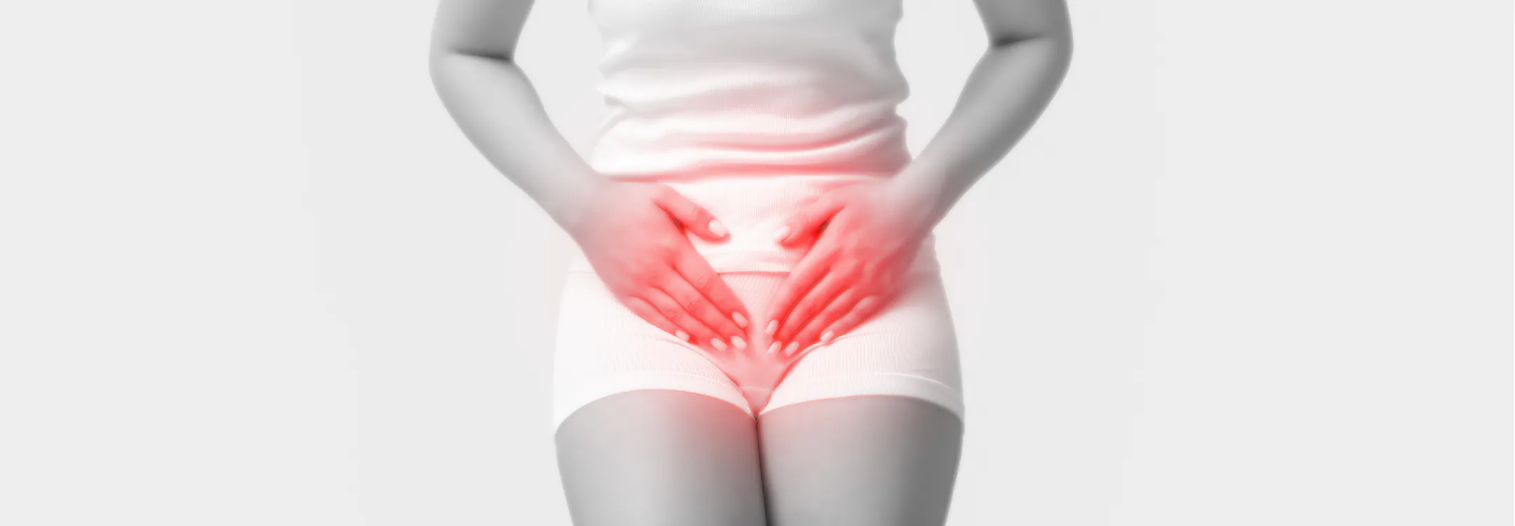 A woman holding her lower abdomen with a red glow indicating pelvic pain.