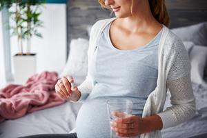 pregnant woman taking pill
