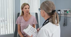Middle-aged patient having appointment with female senior physician