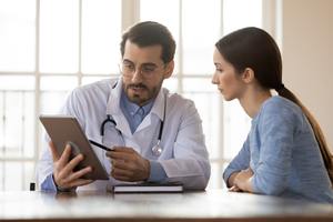 woman discussing colposcopy with doctor.