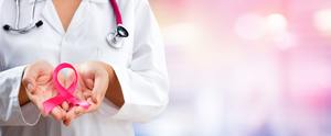 Doctor holding breast cancer ribbon.