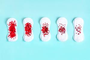 red glitter on menstrual pad - a period concept